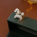 Macro shot of silver poodle brooch with sparkling white rhinestones on jewelry box - Poodle Shape / Silver
