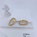Detail of a 21x38mm gold oval pave lobster clasp on a white stone tray with a statue - Gold Large Oval Clasp