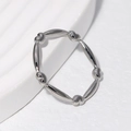 Minimalist silver heart and olive bead stainless steel ring on a white background - US 6 / Steel