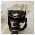 Detail of the black saddle bag with embroidered heart pattern and gold metal hardware - Black