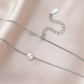 Detailed view of white pearl pendant with silver box chain and lobster clasp - Single Pearl Necklace (Silver Color)