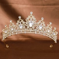 Elegant gold bridal crown with sparkling clear rhinestones on a brown silk background - Gold