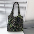 Detail of floral canvas tote bag showing soft fabric texture and colorful wave patterns - Green and Black Curves