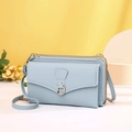 Detail of light blue crossbody phone bag with litchi texture and gold metal ring buckle - Blue