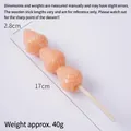 Realistic artificial meatball skewer model with pink textured spheres and wooden stick - Orange Strawberry Candied Fruit Skewer