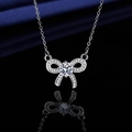 Elegant silver bow pendant necklace with round sparkling diamond and pave setting - Xl-102