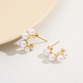 Golden C-shaped earrings with graduated white pearls on a minimalist background - 18K Gold Plated / Gold