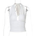 Detail of white halter neck top with cross-wrap design on a mannequin display - S / White
