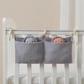 Detail of grey double-pocket cotton crib organizer bag with soft gauze texture and ties - Dark Gray