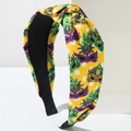 Close-up of fabric knotted headband with carnival mask prints and white polka dots - Yellow