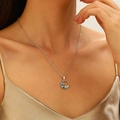 Blue ocean wave sun pendant necklace in silver finish worn by a female model - Round Sea Wave Sun Style (N-854)