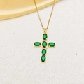Detail of gold cross necklace featuring oval emerald green stones and zircon accents - Gold Green