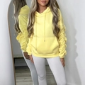 Detail of yellow drawstring hoodie featuring stylish ruched sleeves and front pocket - S / Yellow