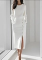 Detail view of white pencil skirt featuring decorative buttons and a side slit design - S / White