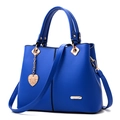 Fashionable royal blue leather tote bag with gold heart pendant and crossbody strap - Blue