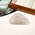 Detailed macro view of pearlescent white semi-circle hair claw clip with aurora finish - PVC 8cm Round Head - Iridescent Grey