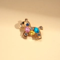 Detailed macro view of rocking horse brooch featuring colorful rhinestones on gold alloy - Multi-color Crystal
