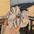 Purple and mint green checkered scrunchie with button detail and woven ring label - Purple Green Plaid Scrunchie with Yellow Button