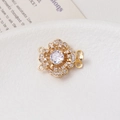 Macro shot of 14K gold-plated flower clasp with micro-set zircons for jewelry making - Camellia / Double Row / White