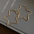 Minimalist gold star-shaped hoop earrings with a polished metallic finish for women - Gold