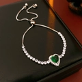 Detail of adjustable silver bracelet featuring a green heart emerald and white zircons - Silver-Green