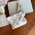 Détail de pochettes à fleurs et d'une pince à cheveux sur un plateau en bois - Base Blanche Hortensia Kaki Violet Clair