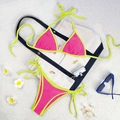 Neon pink bikini set with bright yellow trim and side ties on a white beach mat - Rose Red/Lime Green
