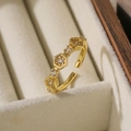 Macro shot of gold-plated geometric honeycomb ring with sparkling cubic zirconia stones - Adjustable Open / Warm Gold