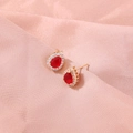Macro shot of gold teardrop earrings with red crystals and small white diamonds - SE815 Red Waterdrop Zirconia