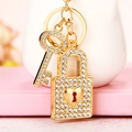 Golden keychain featuring a crystal-encrusted key and a heart-shaped padlock charm - Gold Heart Lock & Key