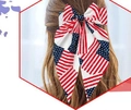 American flag bow hair clip with red white stripes and stars on brown hair - Spring Clips / Blue and Red