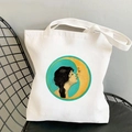 White canvas tote bag featuring a vintage sun and moon art print on a metal chair - STD438-L (Lake Blue Female and Crescent Moon)