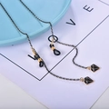 Black and gold glasses chain featuring geometric diamond pendants and silicone loops - Black Gold Diamond