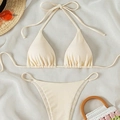 Off-white ribbed halter bikini set with tie-side bottom displayed on summer backdrop - Apricot