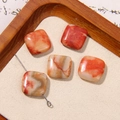 Five square natural agate stone beads with red and orange textures on a wooden tray - Red White Orange Mottled Square Style (26号)