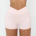 Cross waist yoga shorts in light pink with high stretch fabric and side pockets - Light Pink