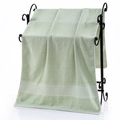 Absorbent light green cotton bath towel with honeycomb woven trim on a black rack - Rice Grid Jacquard Bath Towel (Light Green) / 70*140cm