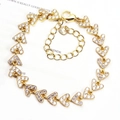 Close-up of golden heart-shaped bracelet with micro-paved zircons and adjustable clasp - Multi-Heart / Gold