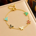 Elegante gouden vlinderketting met kleurrijke edelsteen hangers op beige dienblad - Vlinder Armband (B1451)