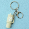 Miniature off-white tumbler keychain with white daisy floral detail and silver metal clip - Keychain / Beige Flower Cup Keychain