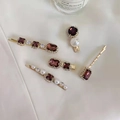 Detail of vintage gold hairpins set with purple gems, pearls and crystals on white silk - Brown Gold 5-Piece Set