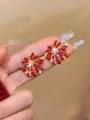 Macro shot of red firework stud earrings with white zircon accents and pearl detail - Style 5 (Gold Pin - Red)