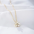 Detailed macro view of an S925 silver flower pendant with a sparkling central zircon stone - 925 Silver / Yellow