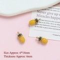 Detailed view of yellow pineapple charm with green leaves for DIY jewelry making - Pineapple