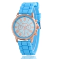 Detailed macro view of Geneva sky blue silicone strap and rose gold quartz watch dial - Light Blue