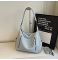 Detail of light blue tote bag with lychee texture and stylish long fringe zippers - Blue