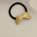 Elastic black hair tie featuring a vintage gold metal bow with hammered texture detail - Pleated Butterfly Wing Gold