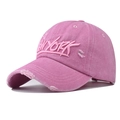 Close-up of pink washed cotton baseball cap with New York embroidery and distressed detail - Adjustable / Pink