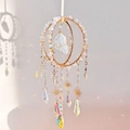Detailed close-up of handmade moonstone suncatcher with prisms casting rainbows on the wall - Opal