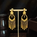 Bohemian gold tassel drop earrings with vintage flower pattern on a jewelry stand - Gold Flower Tubular Tassel